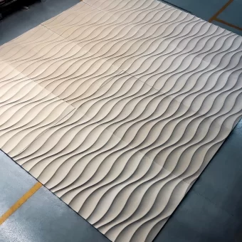 A large-scale accent wall panel made of high-quality MDF, featuring a continuous, flowing 3D wave pattern designed for modern interior texture.
