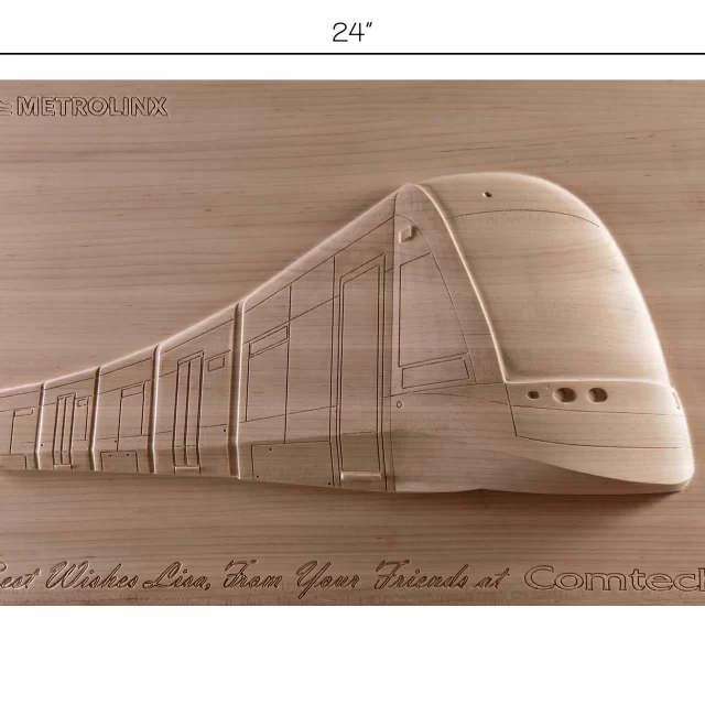 A unique piece of wooden wall art featuring a precision-carved profile of a modern, streamlined metro train, showing window details and aerodynamic curves.