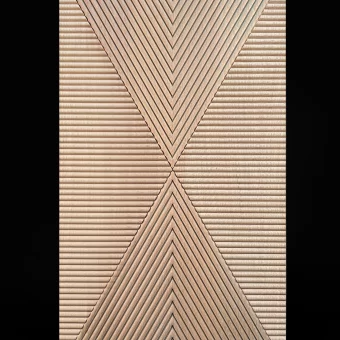 A precision-engineered wood panel featuring reeded slats arranged in a decorative criss-cross or chevron pattern, showcasing technical custom wood fabrication for architectural custom woodwork.