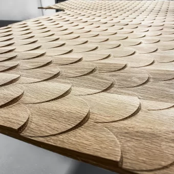 A tight close-up of a scalloped fish scale wood grain pattern, highlighting the tactile quality and refined craftsmanship of high-end custom wood fabrication in custom woodwork.