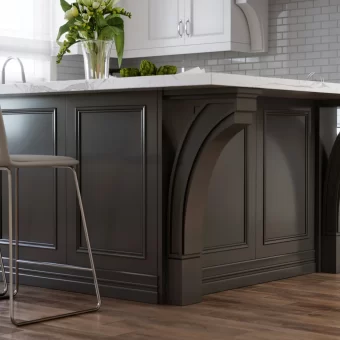 A dark-finished kitchen island featuring oversized, custom-carved maple corbels as structural supports, providing a dramatic architectural element to the cabinetry.