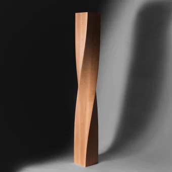 A sleek, contemporary furniture leg carved from a single block of wood, featuring a sharp 360-degree spiral twist within a rectangular profile.