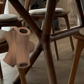 A dark-stained, hollow rectangular block designed as a structural or decorative element for high-end furniture, highlighting clean custom wood fabrication techniques.