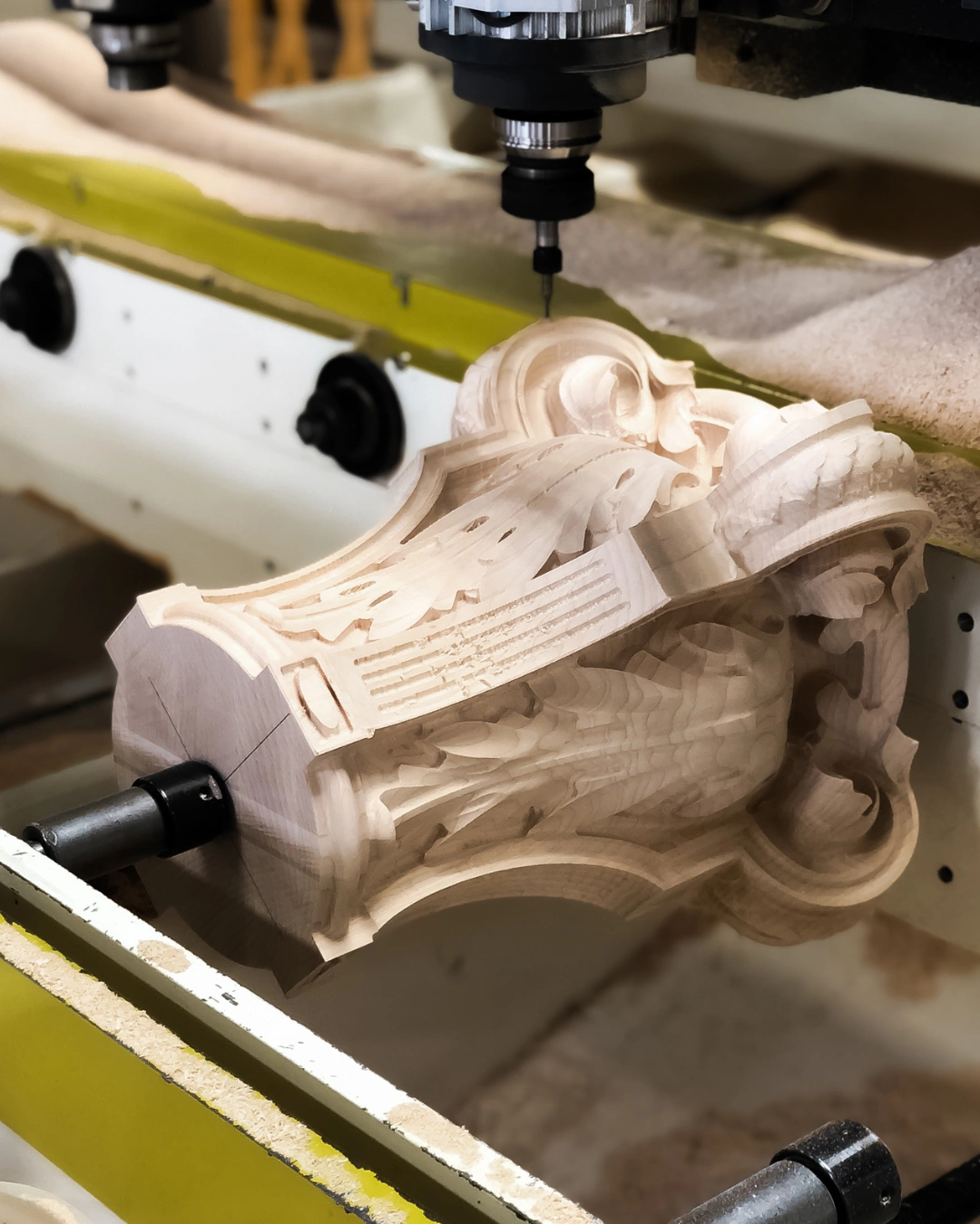 CNC machine carving detailed patterns into custom wood components
