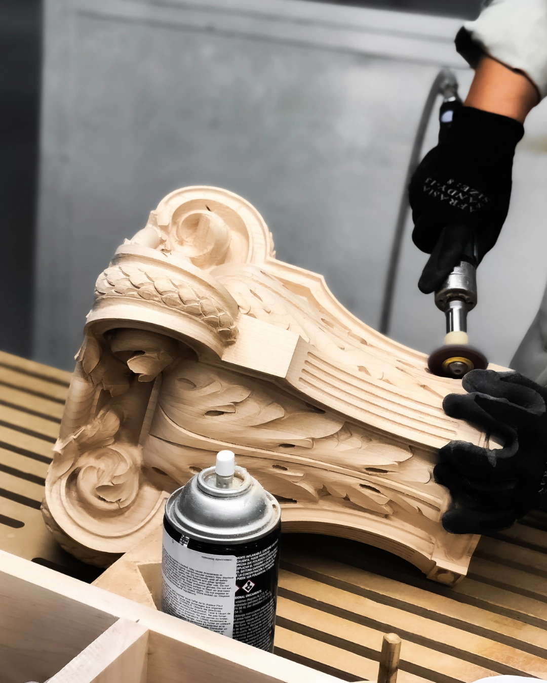 Hand sanding custom wood carving for a smooth finished surface