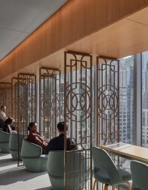 Solid wood Art Deco geometric fretwork panels installed as room divider partitions in a modern lounge, one-piece CNC millwork handcrafted in Canada and shipped across the USA and Canada.